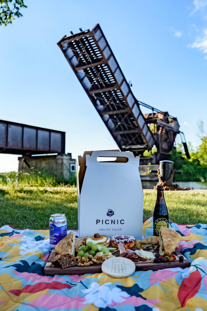 gourmet picnic with old lift bridge in background 