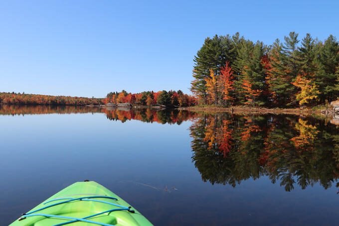 kayak front, lake, autumn trees