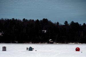 ice fishing huts on frozen lake