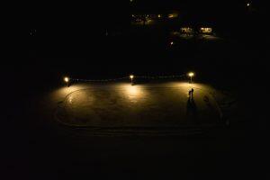 lighted outdoor skating rink at night