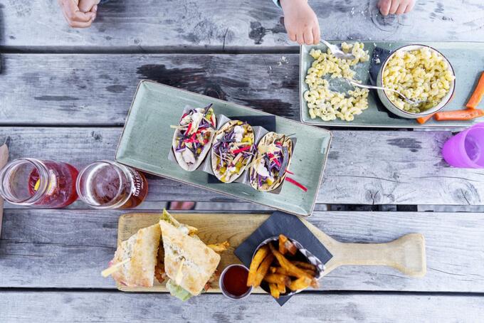 platters of food and diners' hands