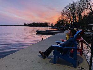 people watching sunset over lake
