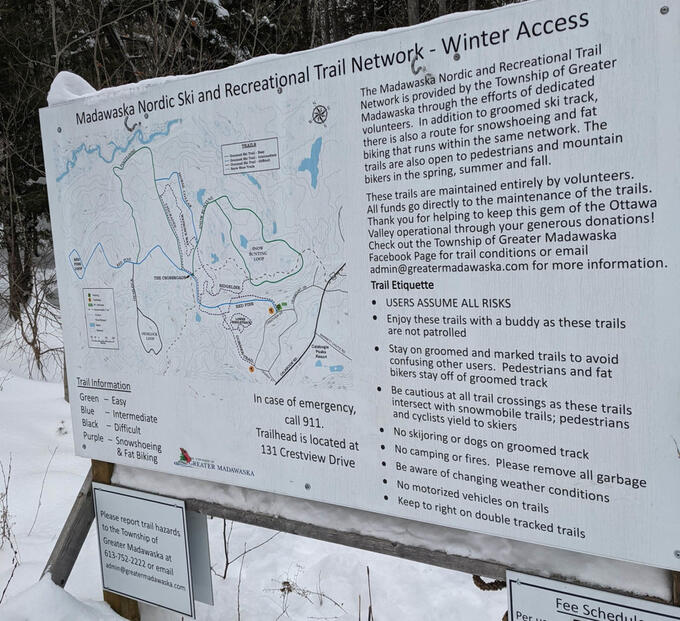 snow-covered informational sign for Madawaska Nordic Ski and Recreational Trail Network, featuring trail map 