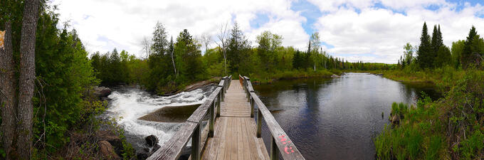 A bridge crosses rapids.