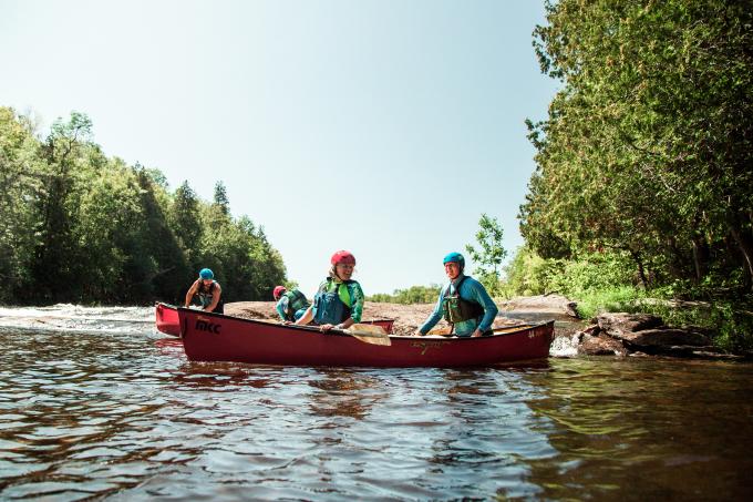 Two people in a canoe paddling.