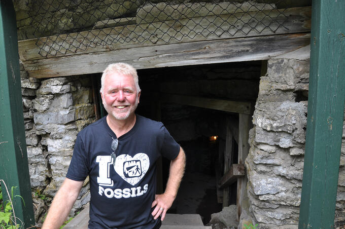 Chris Hinsperger stands in front of cave entrance