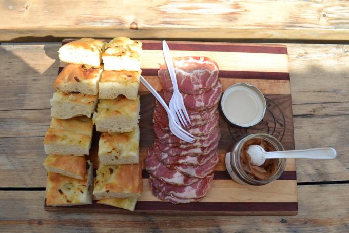 charcuterie board covered in italian bread and cured meat 