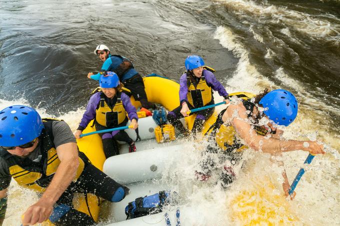 A boat of paddlers in a raft on the Ottawa River.