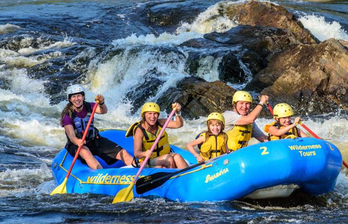 A boat of paddlers in a raft on the Ottawa River.