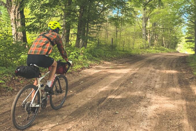 Man rides on bicycle on a forest trail