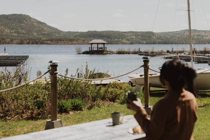 A woman stands looking out at the waterfront in Deep River