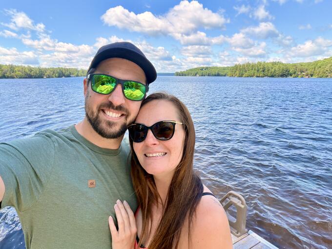 A man and a woman stand on a dock