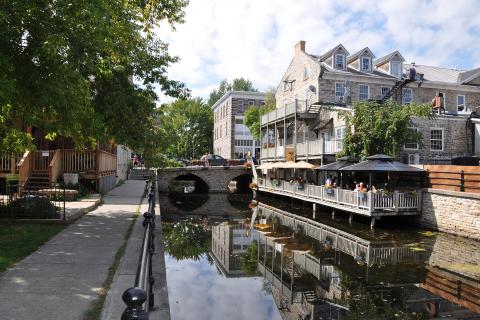 shops and tree-lined walking trail along canal in Perth