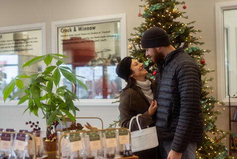A man and woman shop in a store together