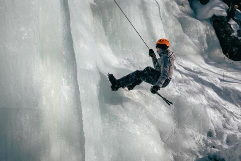 A man climbs a sheet of ice