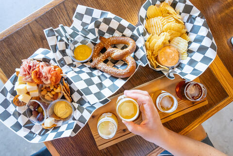 A table is loaded with food and beer.